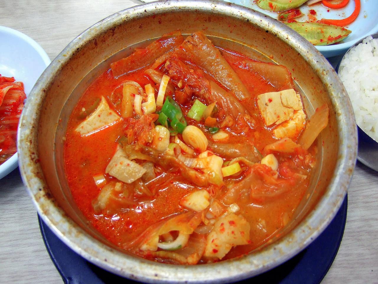 A bubbling pot of kimchi jjigae stew with pork and tofu