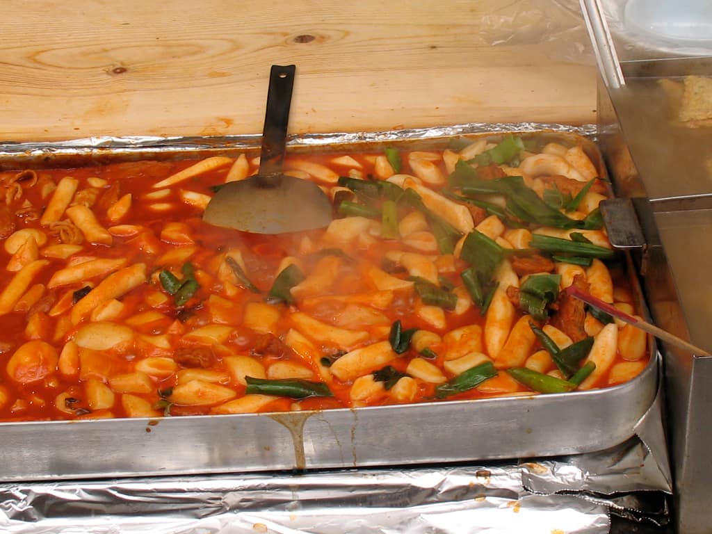 Tteokbokki, cylindrical rice cakes in a thick red gochujang sauce