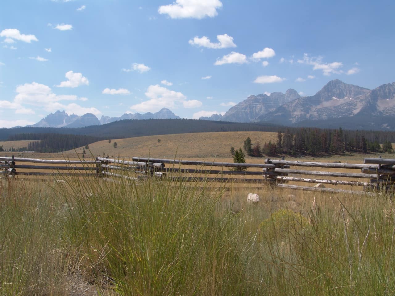 Jagged peaks of the Sawtooth Mountains rising behind open sagebrush country south of Stanley, Idaho